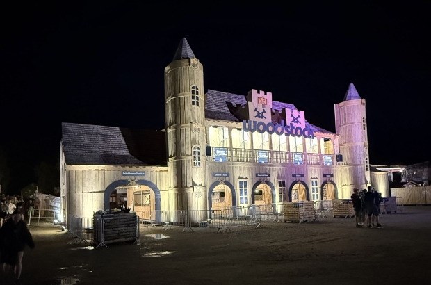 Ein hölzernes Bauwerk das an eine Burg erinnert. Es ist eine Nachtaufnahme.